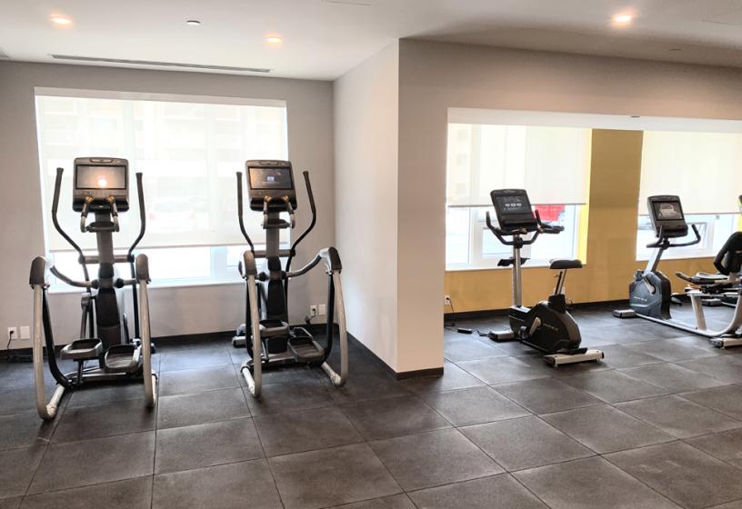 Onsite fitness room with cardio and weight training equipment.